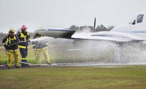 Firefighters extinguish the port side engine of an aircraft that caught fire at the airport . Firefighters extinguish the port side engine of an aircraft that caught fire at the airport .